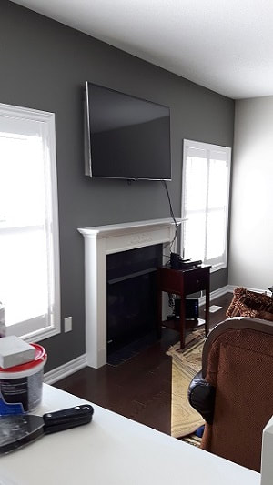 Brampton home with painted fireplace against a painted grey wall.